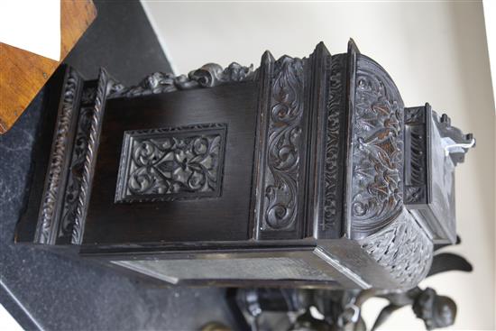 A late 19th century Maple & Co carved and ebonised oak chiming bracket clock, 23in., overall height 34in.